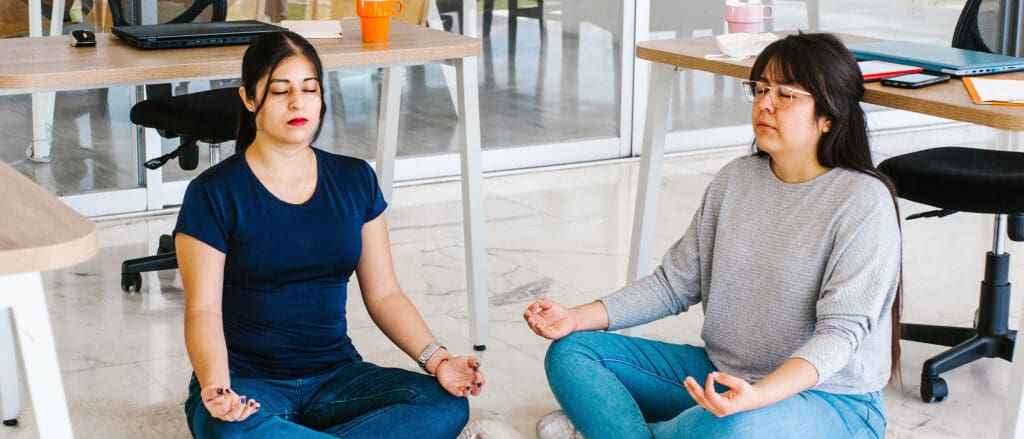 Two women meditating