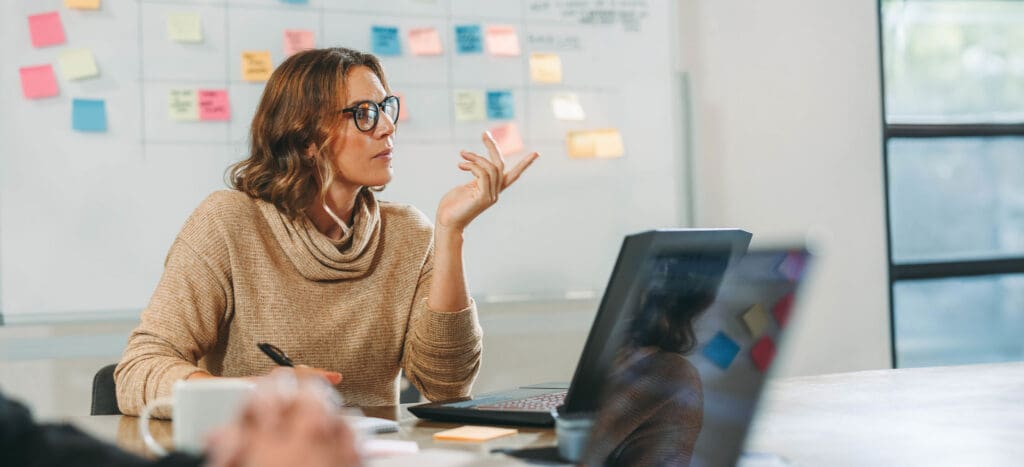 Agile Transformation professional working on laptop in conference room