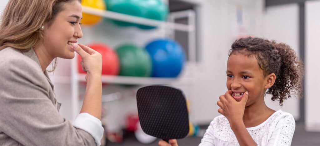 Speech Language Pathologist helping child with speech