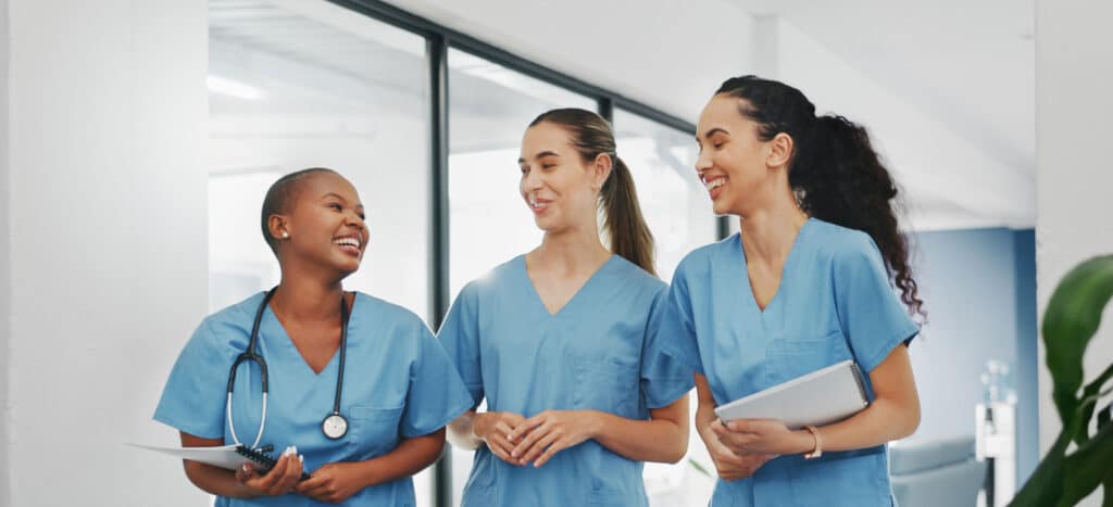 Group of healthcare professionals smiling, walking