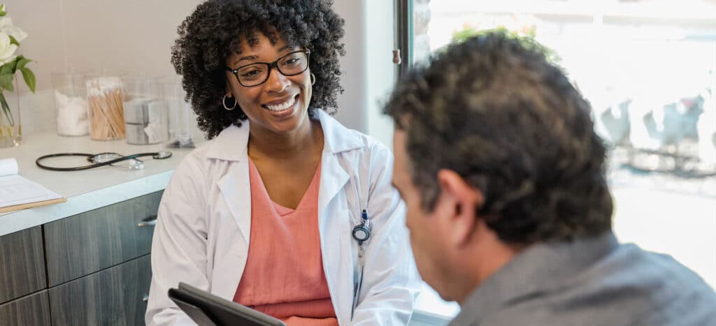 Female nurse helping male patient