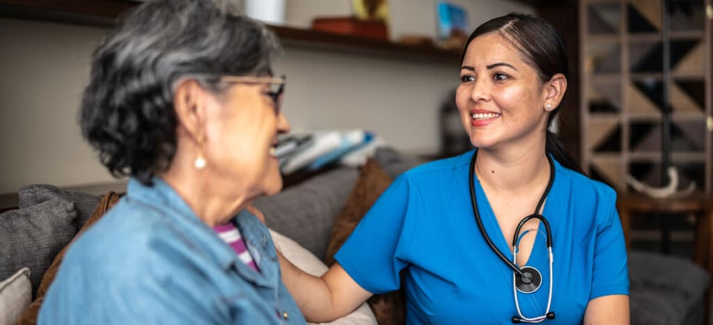 Female Nurse helping older female patient