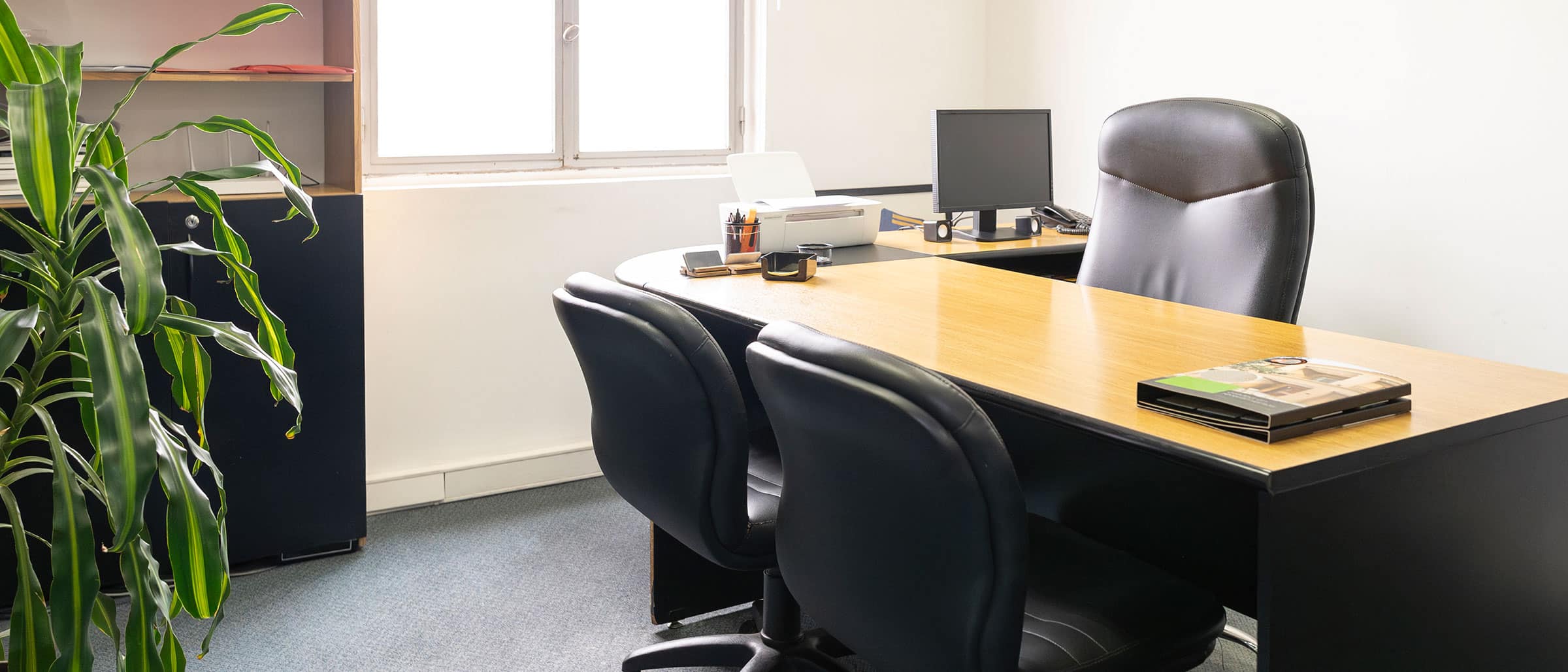 Empty office desk with 3 chairs