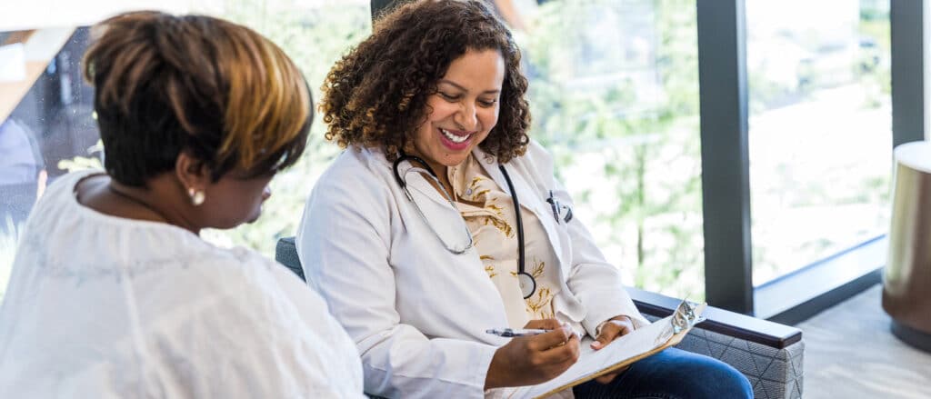 Nurse practitioner showing a patient their medical records