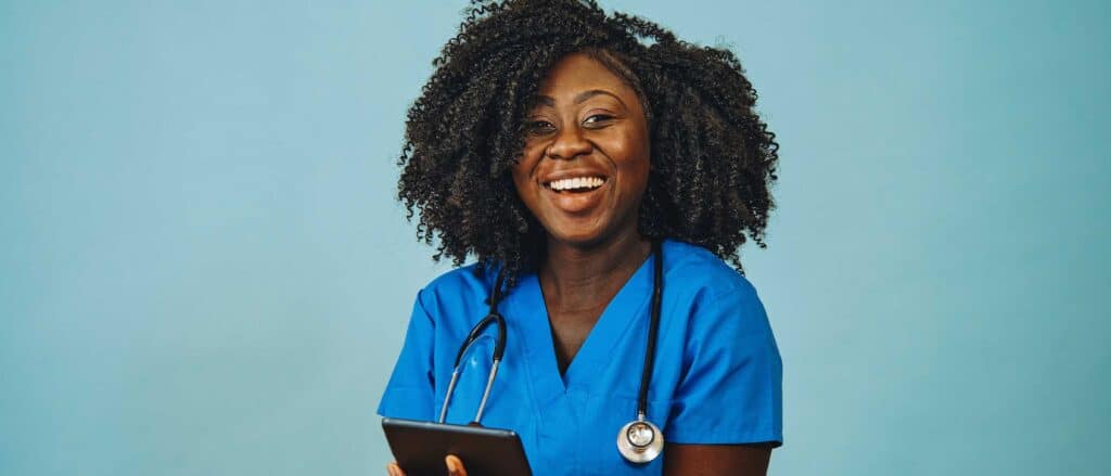 Healthcare worker wearing stethoscope smiling