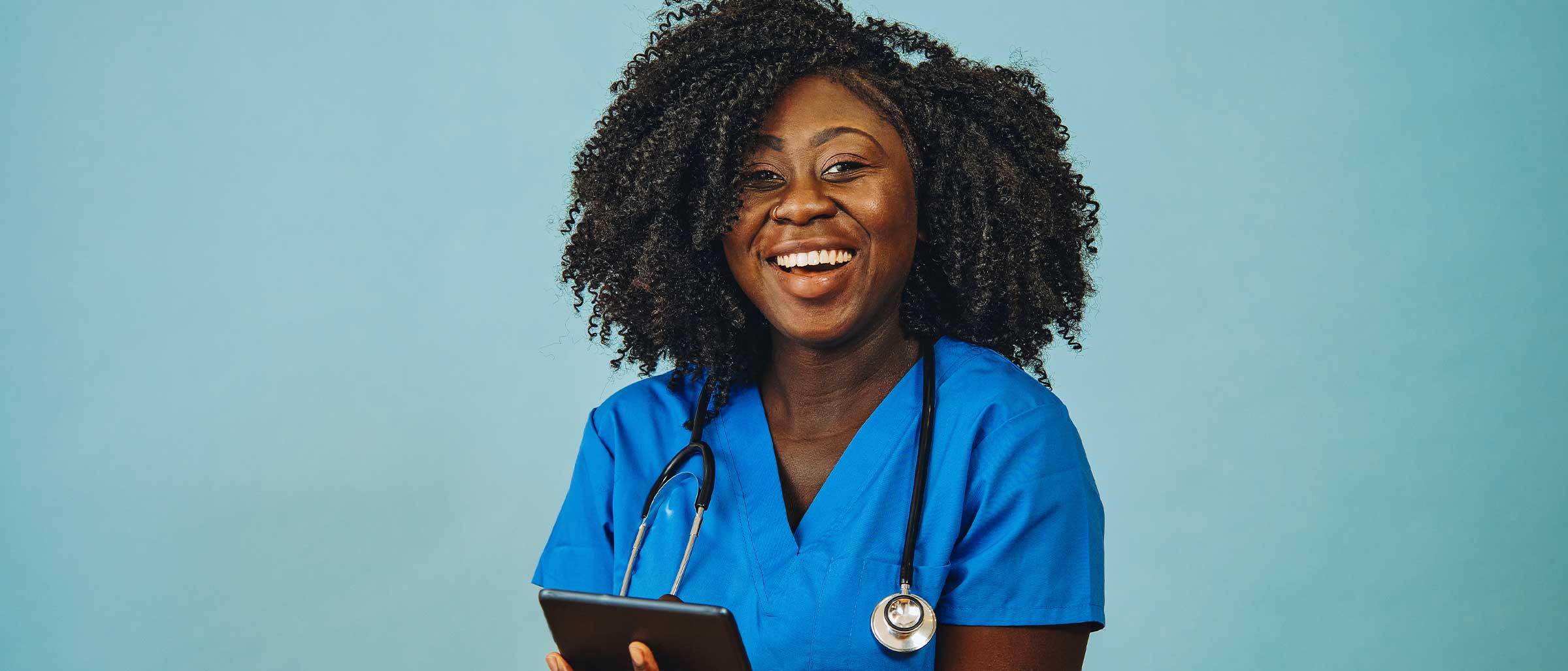 Healthcare worker wearing stethoscope smiling