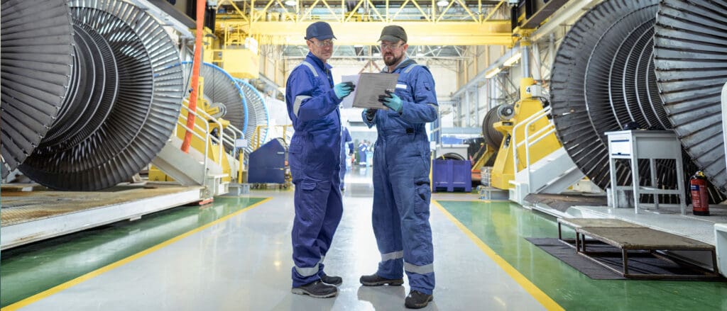 Two manufacturing professionals standing in a factory