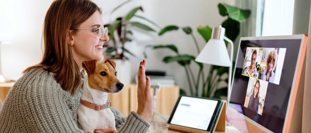 Woman working remotely, from home, in a video call with co-workers