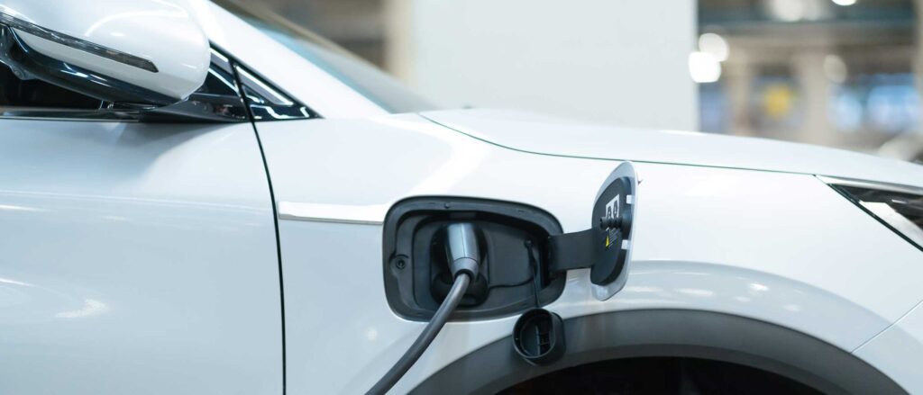 Close up of electric car plugged into charger