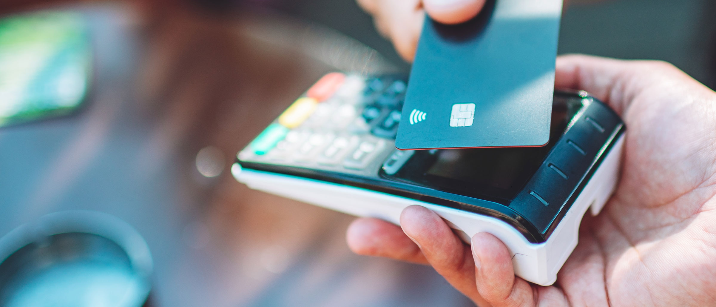 Close up of someone tapping their card on a card reader