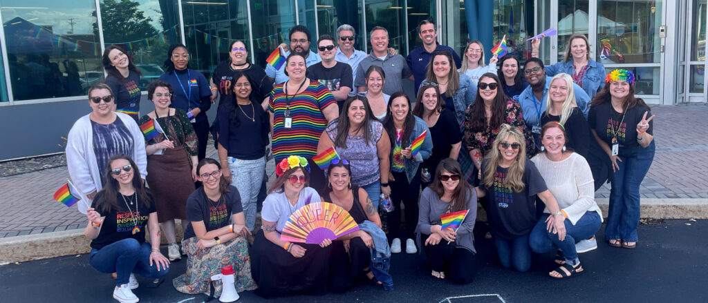 Judge employees dressed in Pride gear in front of HQ