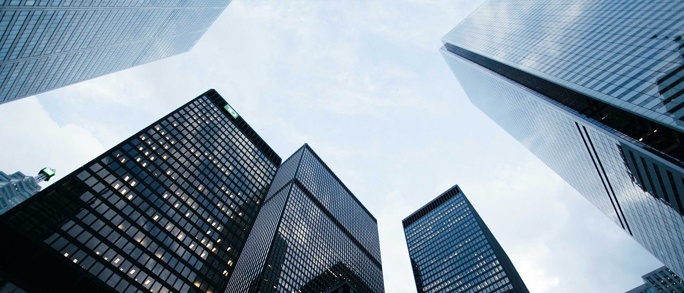 Ground view looking up at tall city buildings