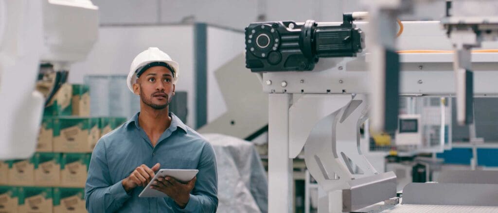 Man in warehouse wearing a hard hat