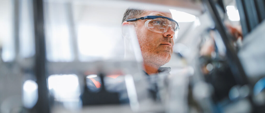 Man wearing safety glasses with background blurred out