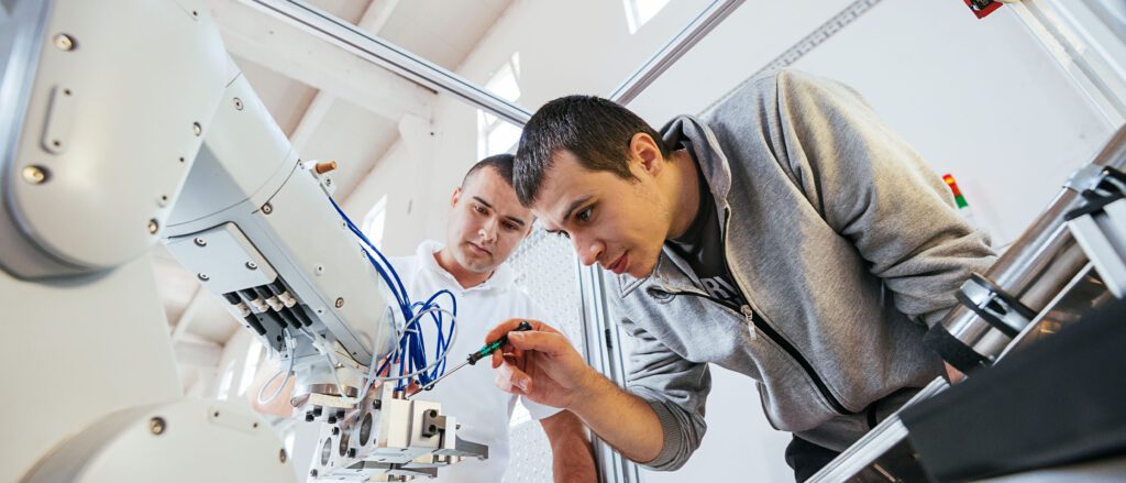 Two engineers working on robotic equipment