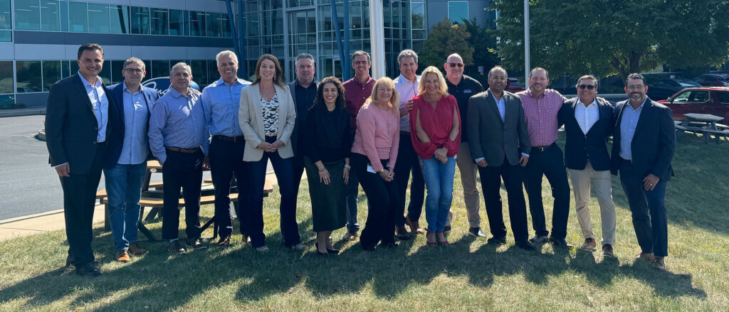 Judge team members standing in front of HQ