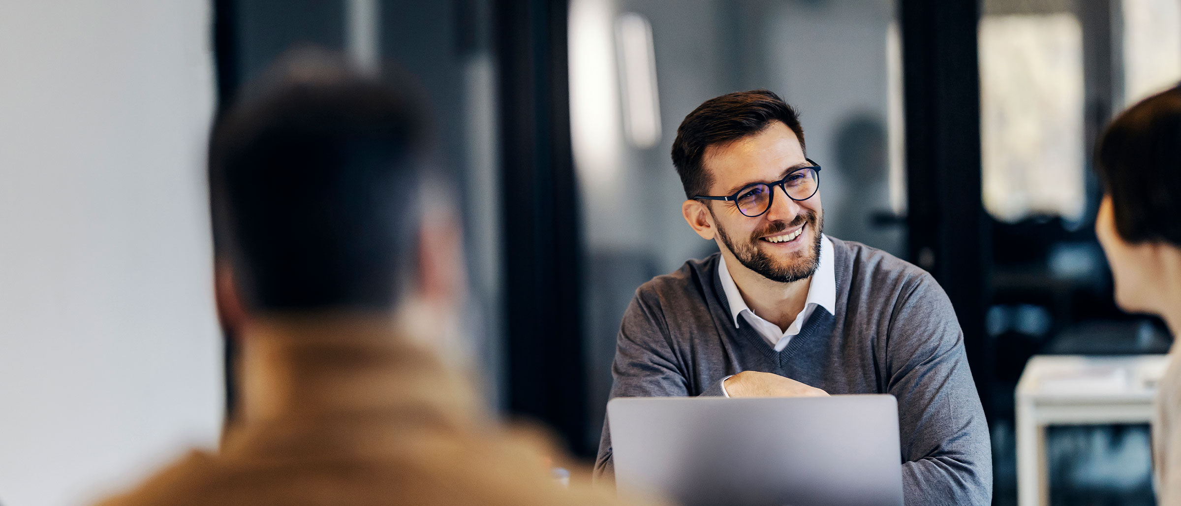 Man looking to the side, smiling, with the rest of photo out of focus