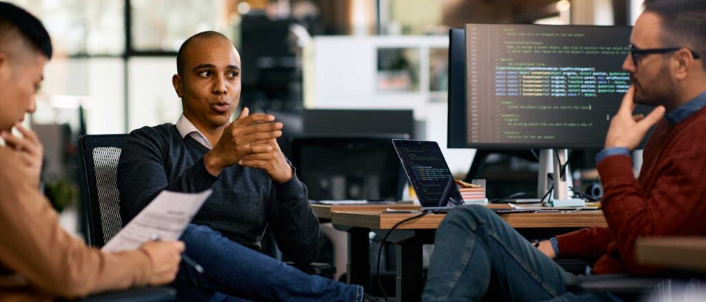 Group of software developers discussing code